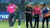 Pakistani wicket keeper hit the ball on the umpire head